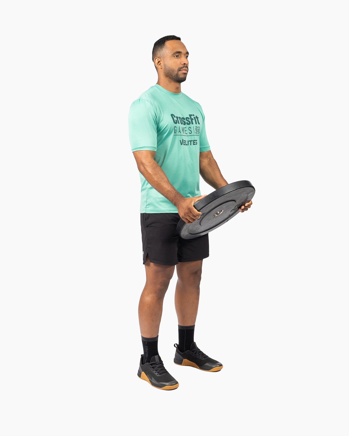 Athlete in the gym wearing the unisex wasabi green commemorative edition t-shirt by Velites