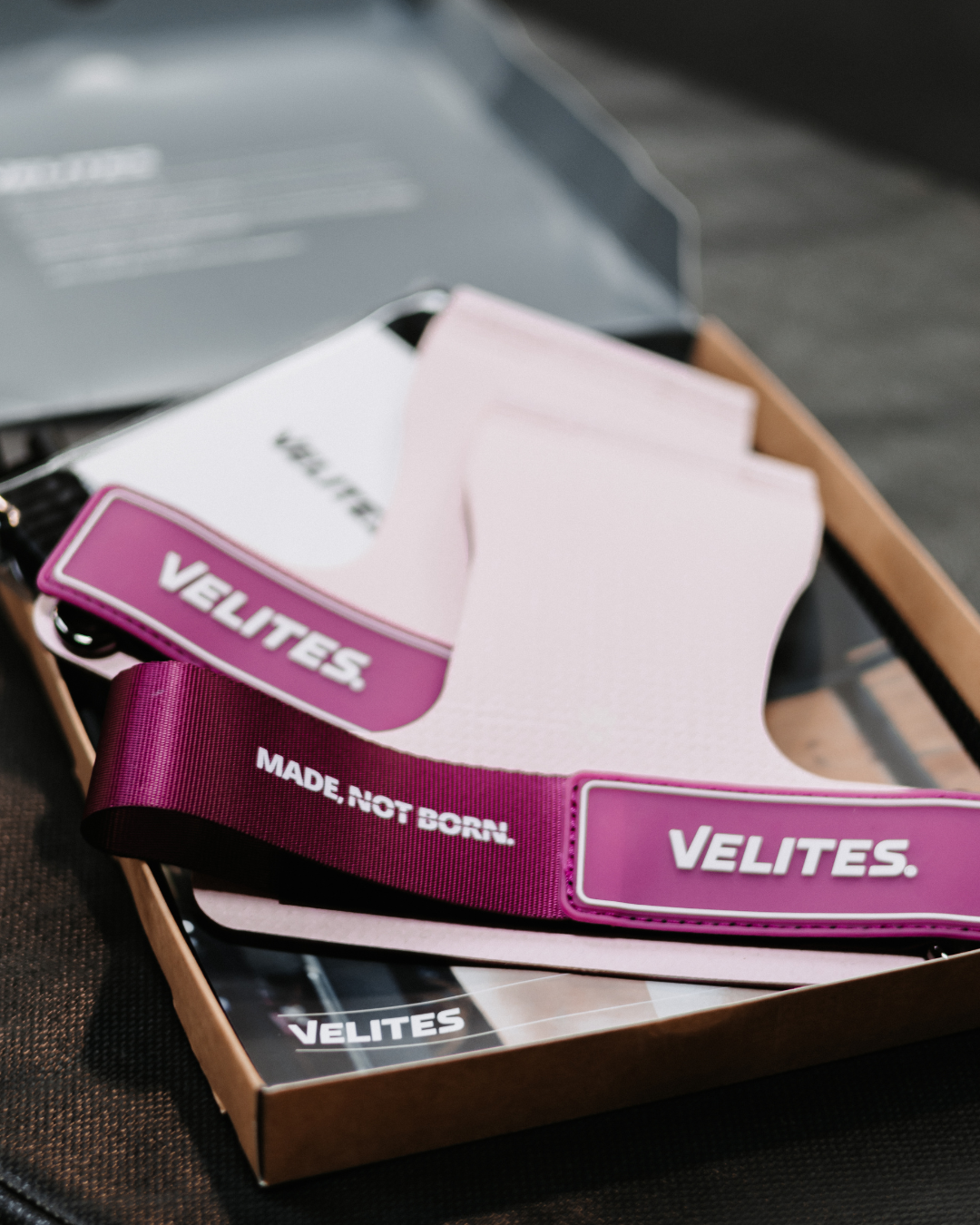 Close-up of new Velites pink grips in box – premium hand grips for CrossFit and functional training